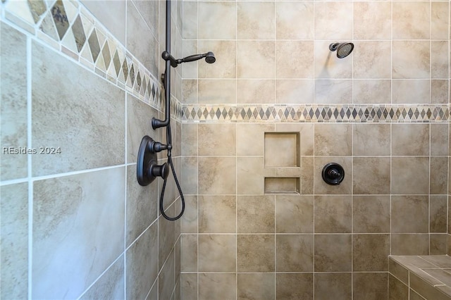 bathroom with tiled shower