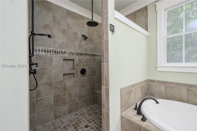 bathroom featuring shower with separate bathtub