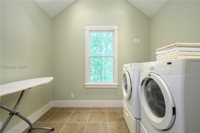 laundry area with separate washer and dryer and light tile patterned flooring