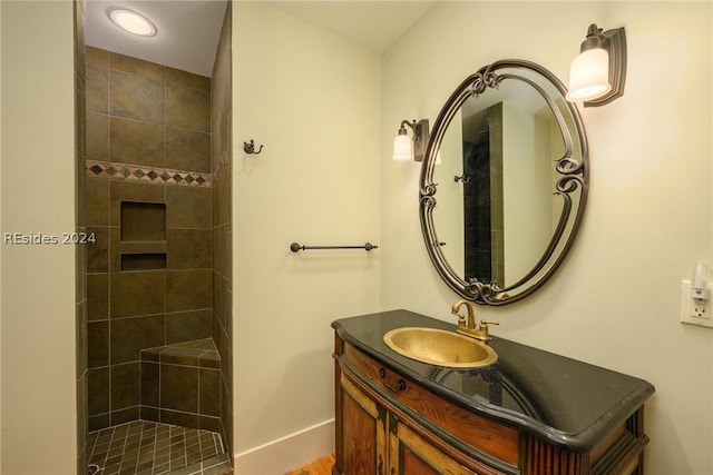 bathroom with vanity and a tile shower