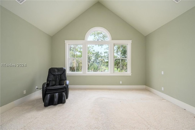 sitting room featuring vaulted ceiling and carpet floors