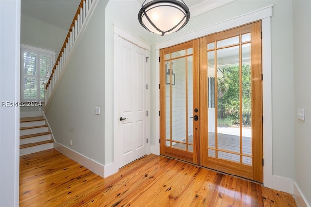 entryway featuring french doors and light hardwood / wood-style flooring