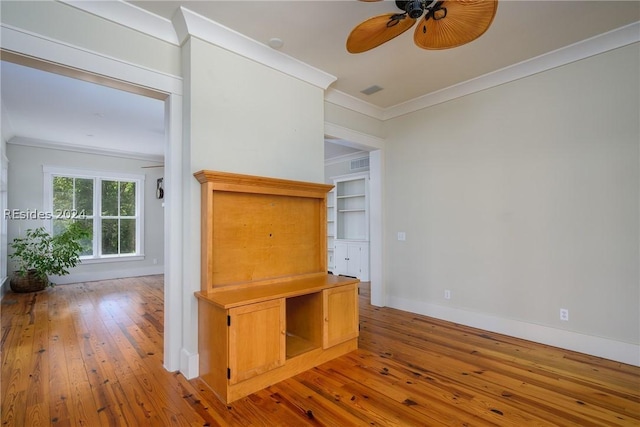 interior space with hardwood / wood-style flooring, crown molding, and ceiling fan