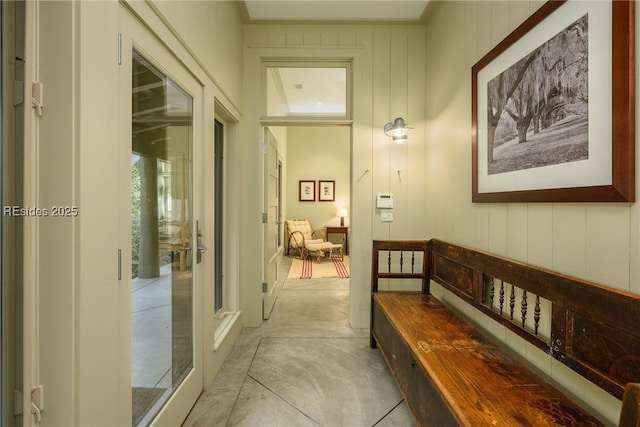 hallway featuring wooden walls