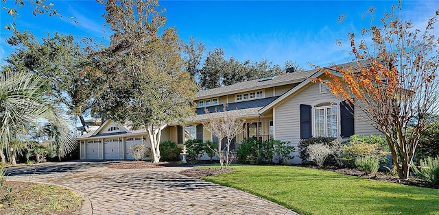 front of property with a garage and a front yard