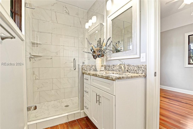 bathroom featuring vanity, ceiling fan, and walk in shower