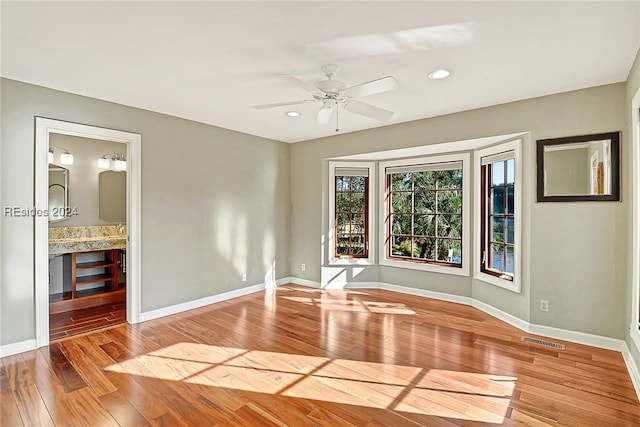 unfurnished room featuring ceiling fan and light wood-type flooring