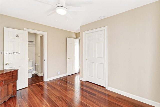 unfurnished bedroom with dark hardwood / wood-style flooring, ceiling fan, and ensuite bath