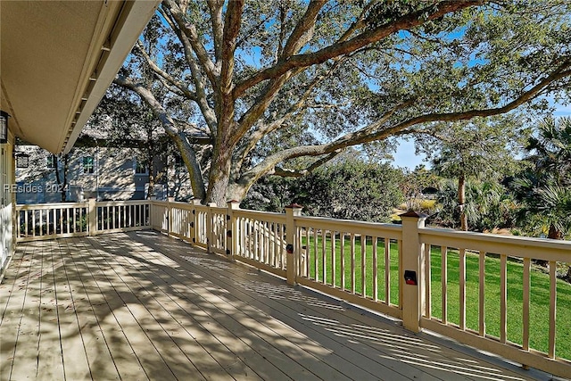 wooden deck with a lawn