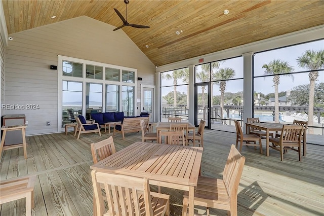 sunroom featuring a water view, lofted ceiling, wood ceiling, and ceiling fan