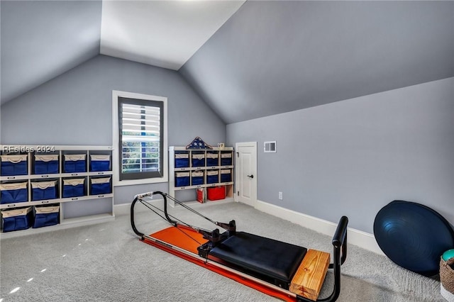 exercise area with lofted ceiling and carpet flooring