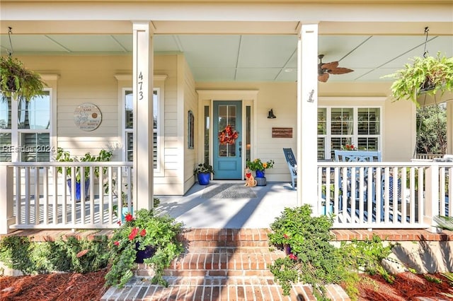 entrance to property with ceiling fan and a porch