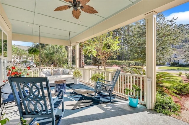 view of patio / terrace featuring ceiling fan, an outdoor living space, and covered porch