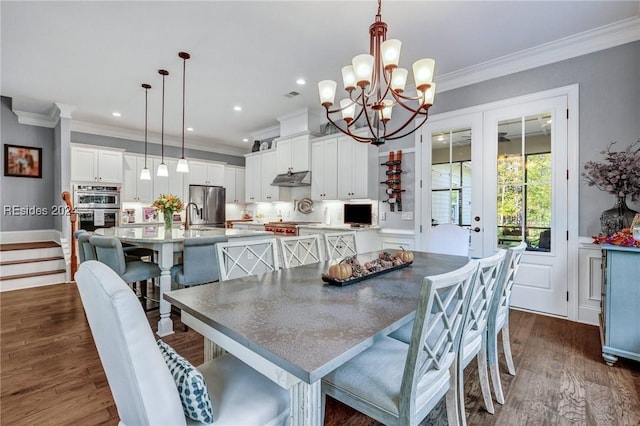 dining space featuring crown molding, dark hardwood / wood-style flooring, and french doors