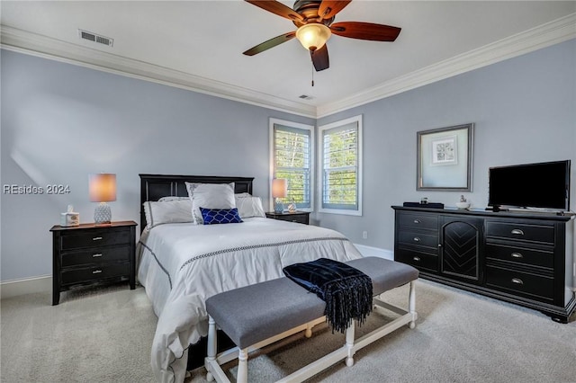 carpeted bedroom with ornamental molding and ceiling fan