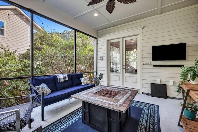 sunroom / solarium featuring ceiling fan