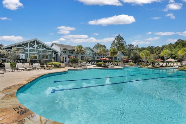 view of swimming pool with a lanai and a patio area