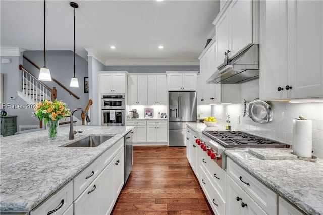 kitchen featuring sink, white cabinetry, stainless steel appliances, light stone countertops, and decorative backsplash