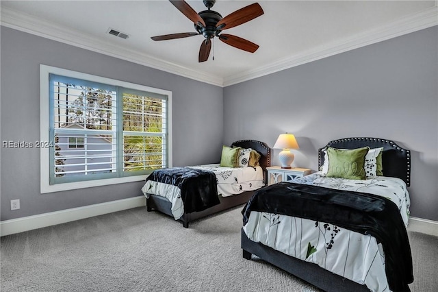 carpeted bedroom with ornamental molding and ceiling fan