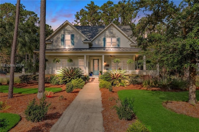 view of front of home with a yard and covered porch