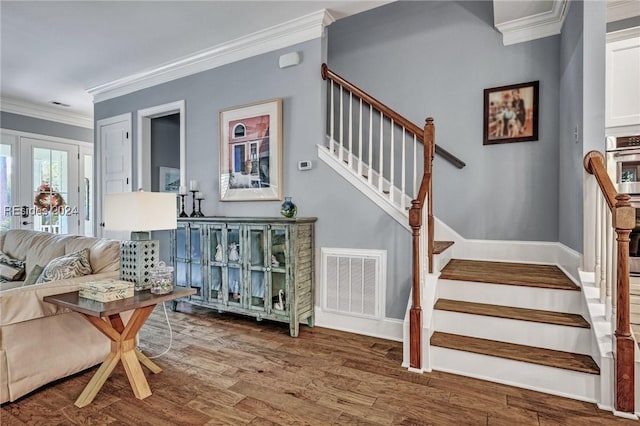 stairs with hardwood / wood-style floors, ornamental molding, and french doors