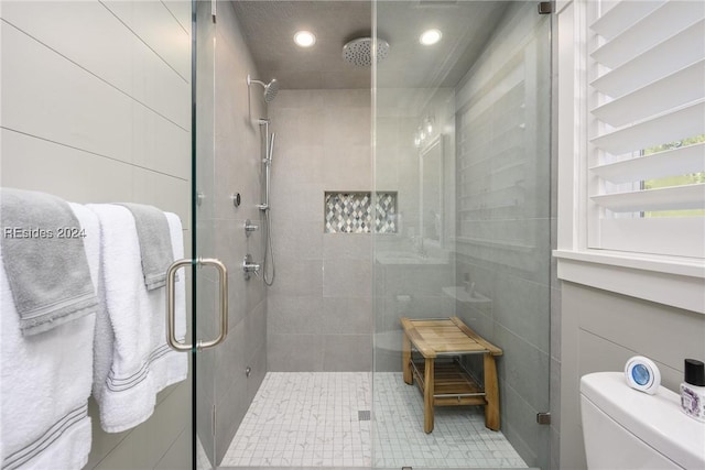 bathroom featuring walk in shower and toilet