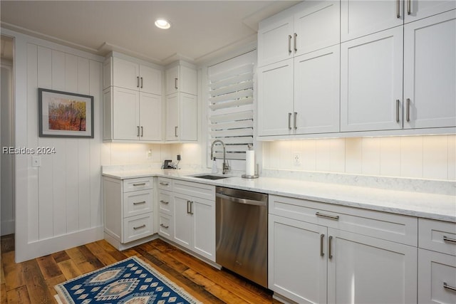 kitchen featuring dark hardwood / wood-style floors, sink, white cabinets, decorative backsplash, and stainless steel dishwasher