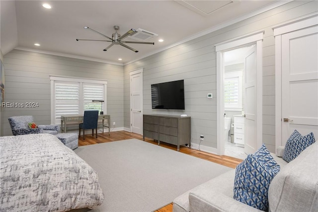 bedroom featuring wood-type flooring, crown molding, ensuite bathroom, and ceiling fan