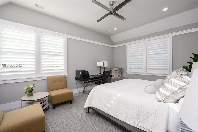 bedroom featuring light carpet, ceiling fan, vaulted ceiling, and multiple windows