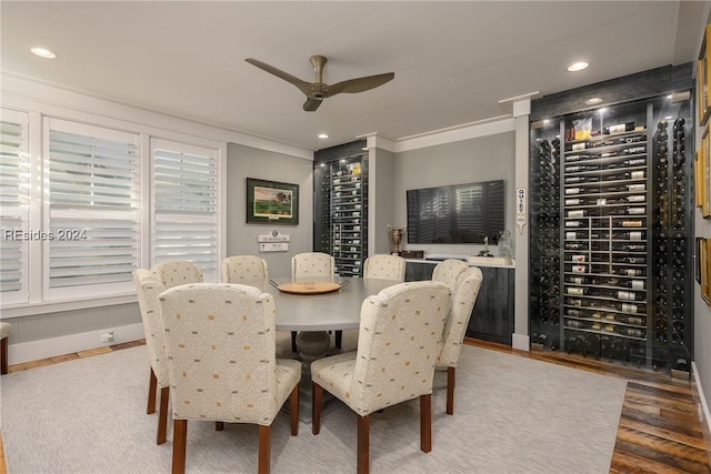 dining space with hardwood / wood-style floors, crown molding, electric panel, and ceiling fan