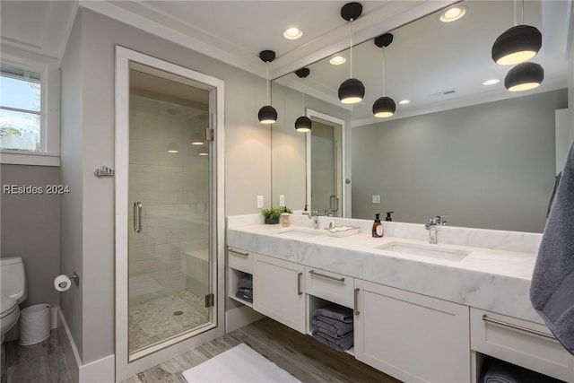 bathroom with walk in shower, vanity, toilet, and hardwood / wood-style floors