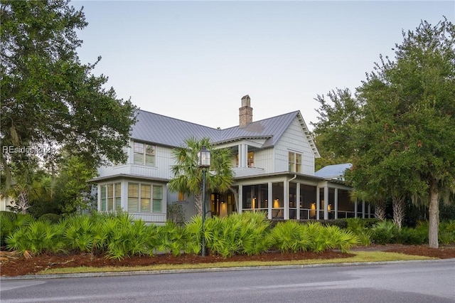 view of side of property with a sunroom