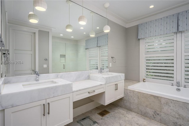 bathroom featuring vanity and shower with separate bathtub