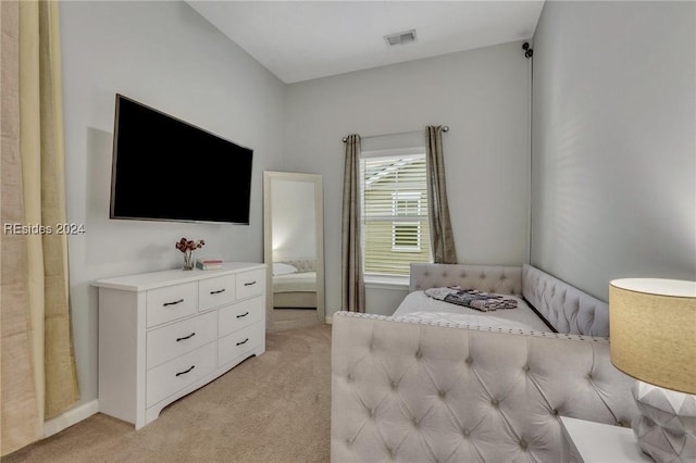 bedroom featuring light carpet