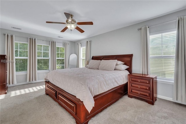 bedroom featuring light carpet and ceiling fan