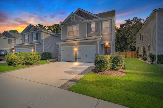 view of front of house with a garage and a yard