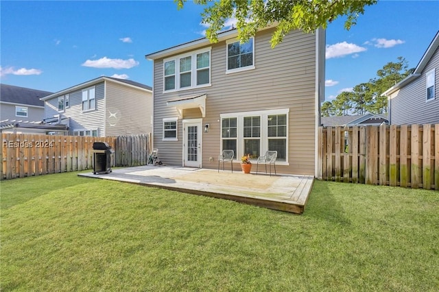 back of house with a patio and a yard