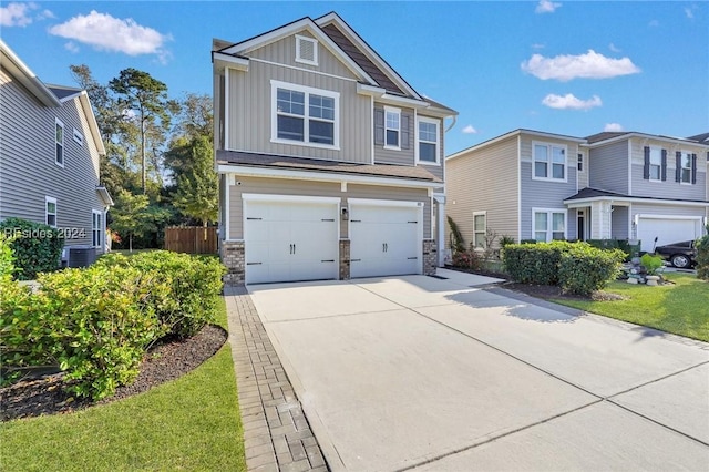 view of front of home with a garage, central AC unit, and a front lawn