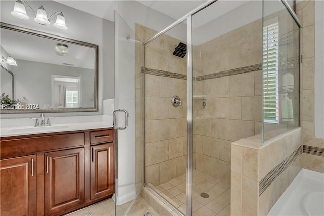 bathroom with tile patterned flooring, vanity, and a shower with shower door