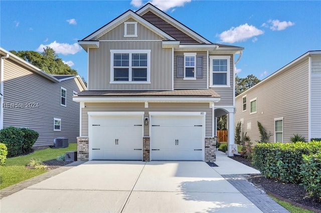 craftsman house with a garage and central air condition unit