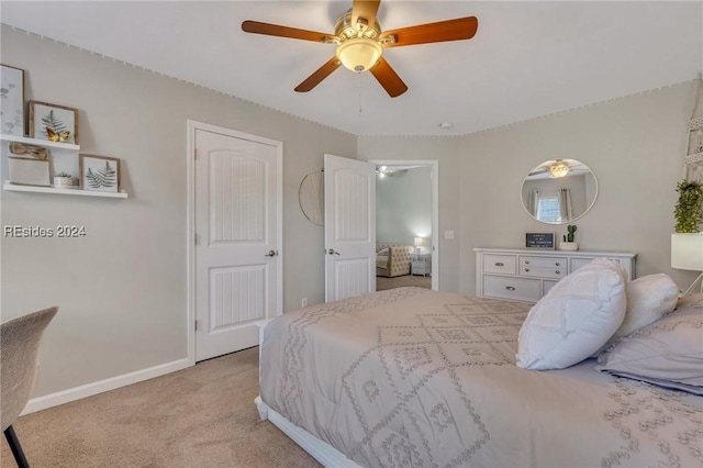 bedroom featuring light colored carpet and ceiling fan