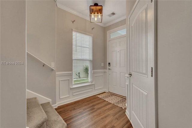 foyer with hardwood / wood-style flooring and ornamental molding