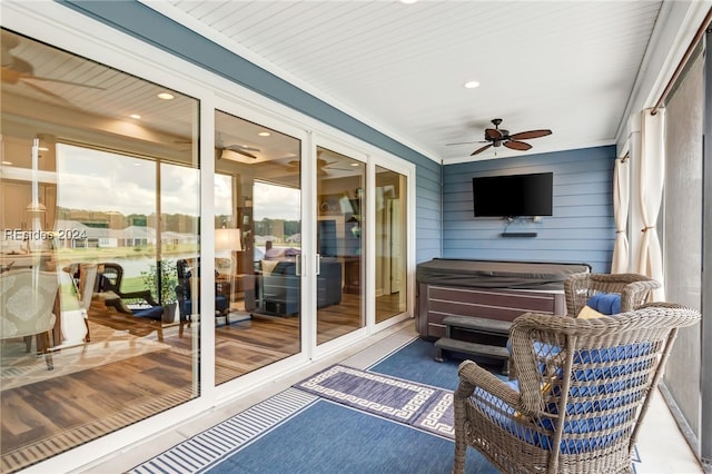 sunroom / solarium featuring ceiling fan