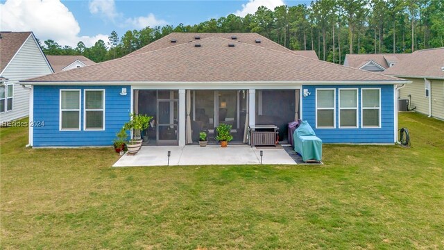 back of house featuring a patio, a sunroom, a yard, and central AC unit