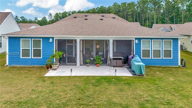 back of house with a sunroom, a patio area, and a lawn