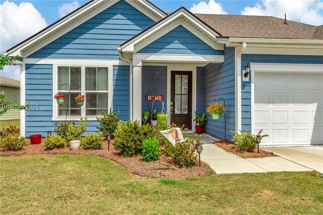 ranch-style house featuring a garage and a front lawn