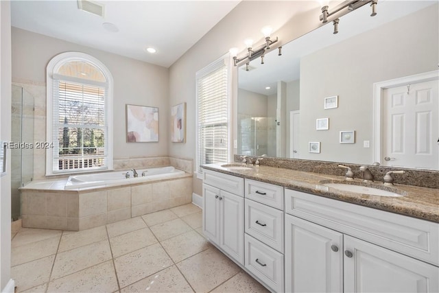 bathroom with plenty of natural light, separate shower and tub, tile patterned flooring, and vanity