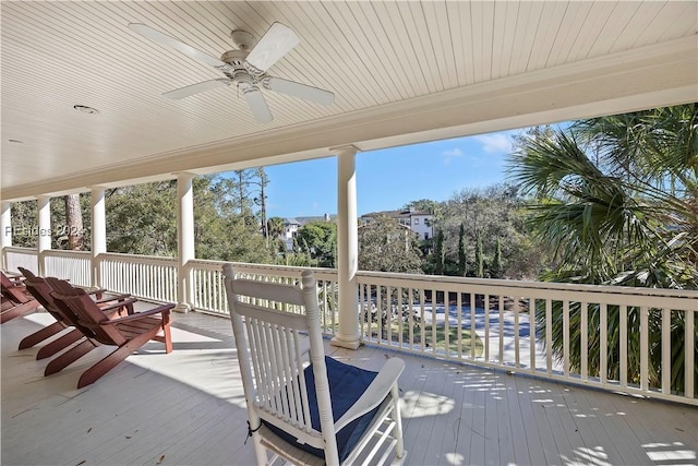 wooden deck featuring ceiling fan