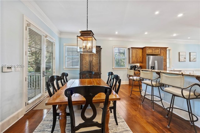 dining space featuring crown molding and dark hardwood / wood-style floors