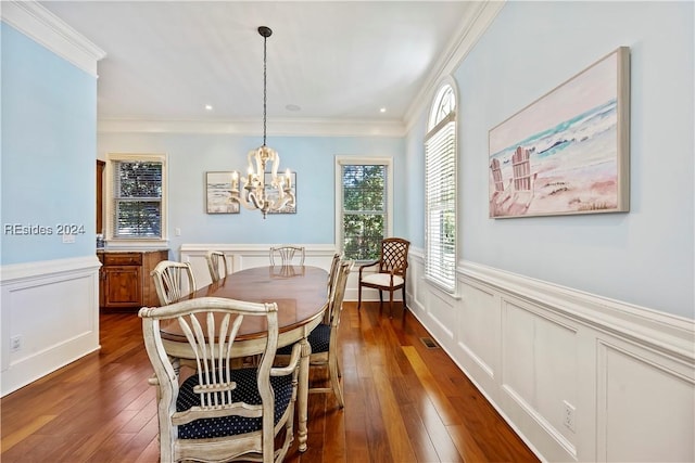 dining area featuring crown molding, dark hardwood / wood-style floors, and a notable chandelier